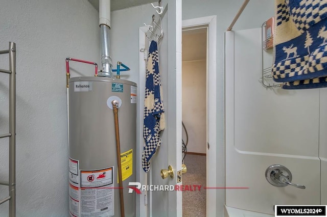 utility room featuring water heater