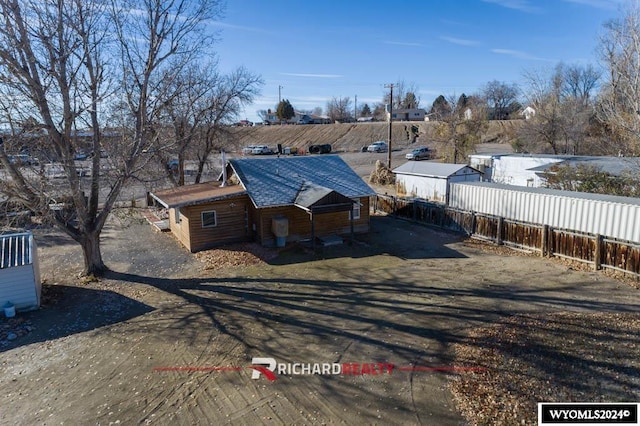 323 Bridge Ave, Worland, WY 82401 - view of front of property with a fenced backyard and roof with shingles