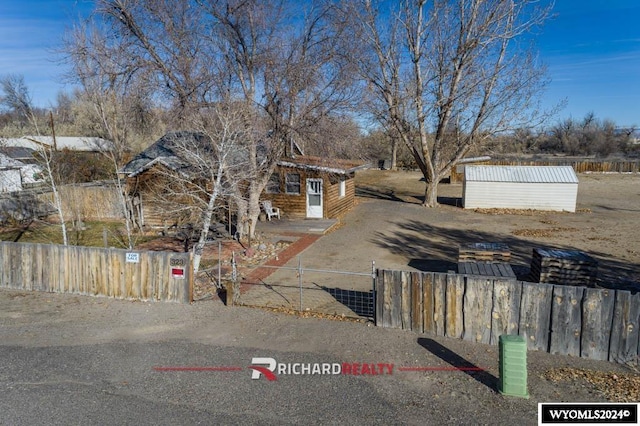 323 Bridge Ave, Worland, WY 82401 - view of front of home with a fenced front yard and an outdoor structure