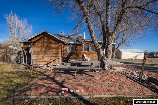 323 Bridge Ave, Worland, WY 82401 - rear view of house with a patio and an outdoor structure