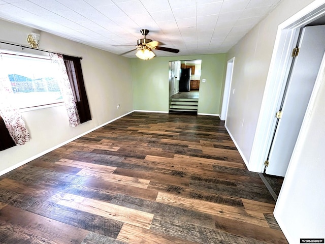 empty room featuring ceiling fan and dark hardwood / wood-style flooring