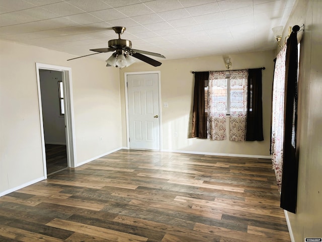 empty room featuring ceiling fan and dark hardwood / wood-style flooring