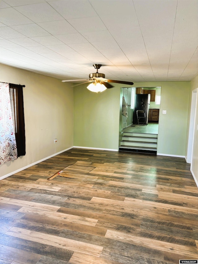 spare room with ceiling fan and dark wood-type flooring