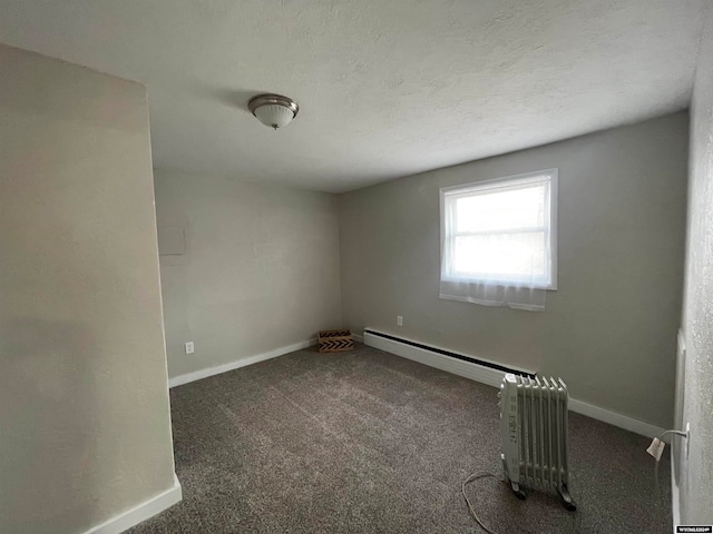 spare room with dark colored carpet