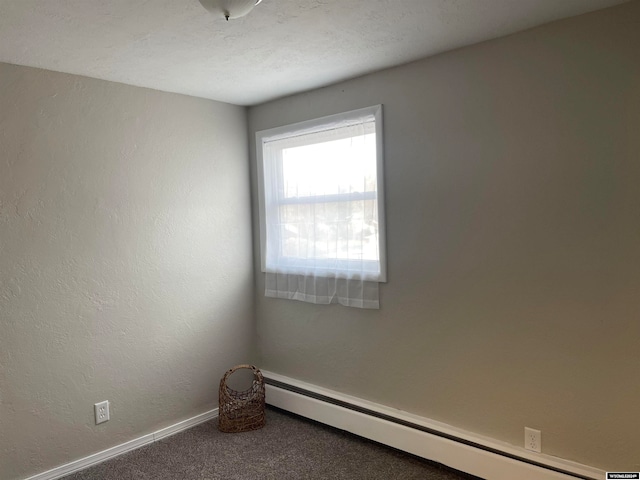 unfurnished room featuring carpet flooring, a baseboard radiator, and a textured ceiling