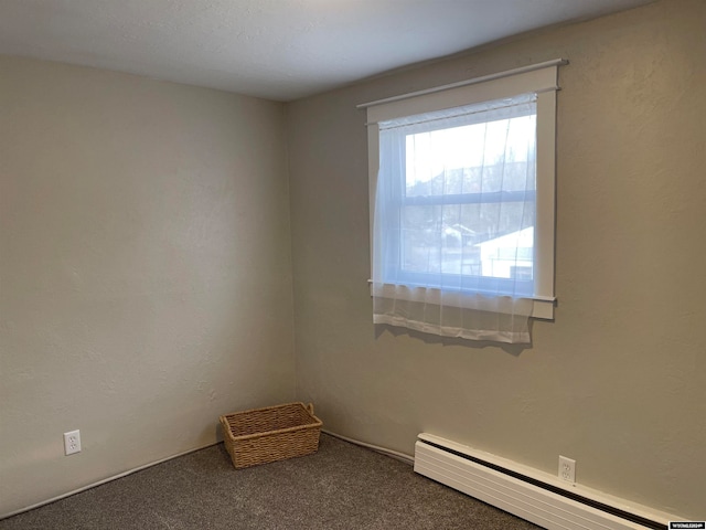 empty room with carpet floors and baseboard heating