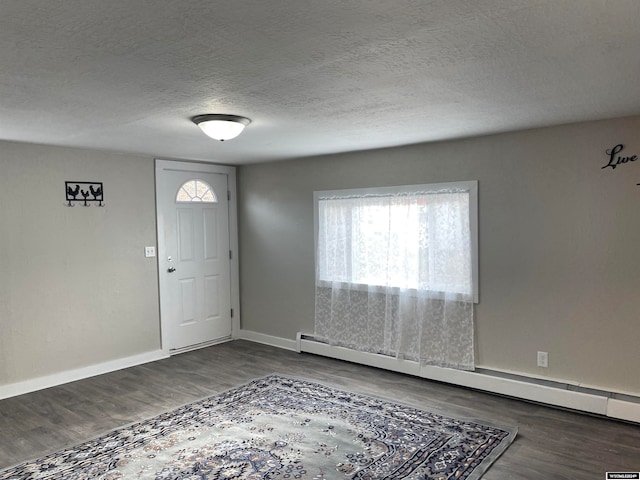 entryway featuring a textured ceiling, a baseboard radiator, and dark hardwood / wood-style floors