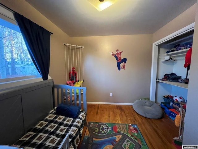 bedroom featuring hardwood / wood-style flooring and a closet