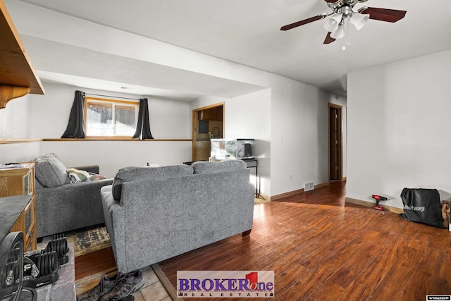 living room featuring hardwood / wood-style flooring and ceiling fan