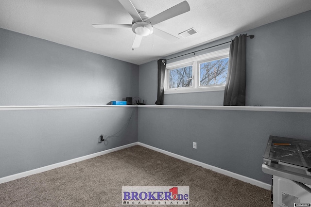 empty room with ceiling fan and carpet floors