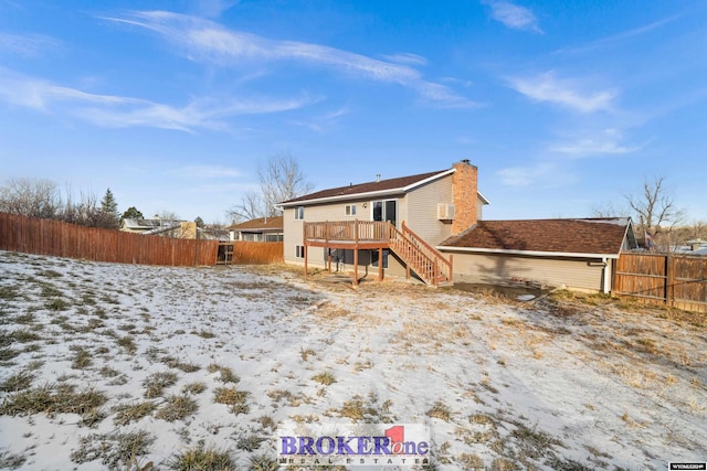 snow covered property featuring a wooden deck