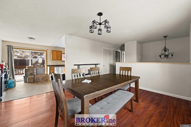 dining area featuring a chandelier, a textured ceiling, and hardwood / wood-style flooring