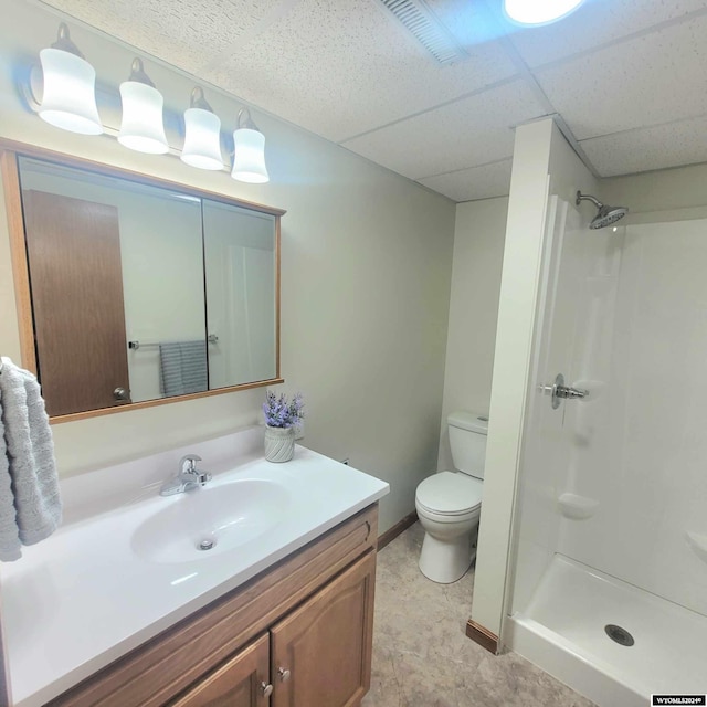 bathroom with vanity, toilet, and a shower