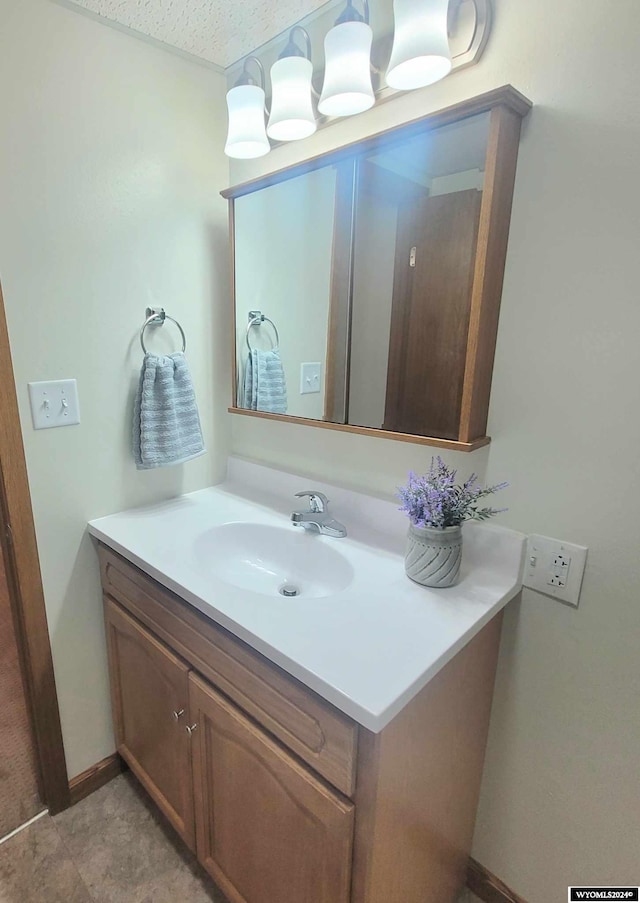 bathroom featuring a textured ceiling and vanity