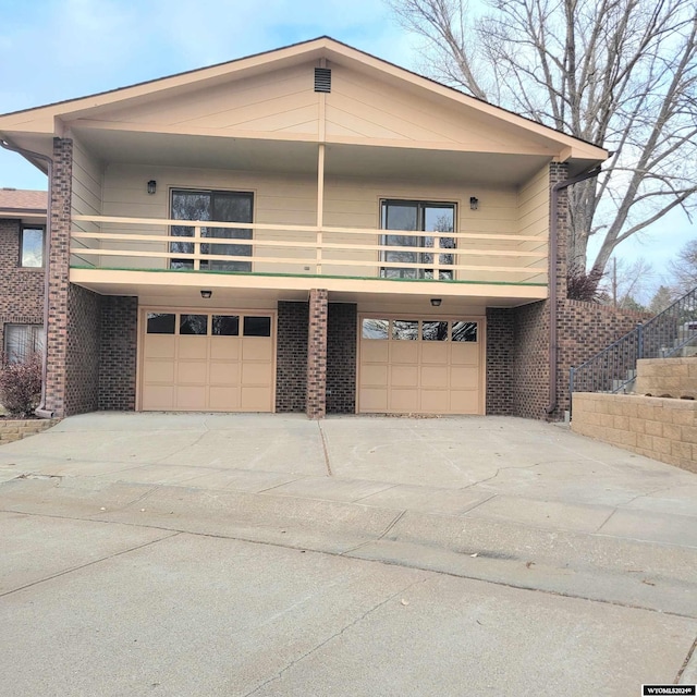 view of front of home with a balcony and a garage