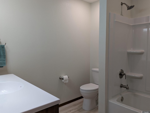 full bathroom featuring shower / bathing tub combination, vanity, hardwood / wood-style flooring, and toilet