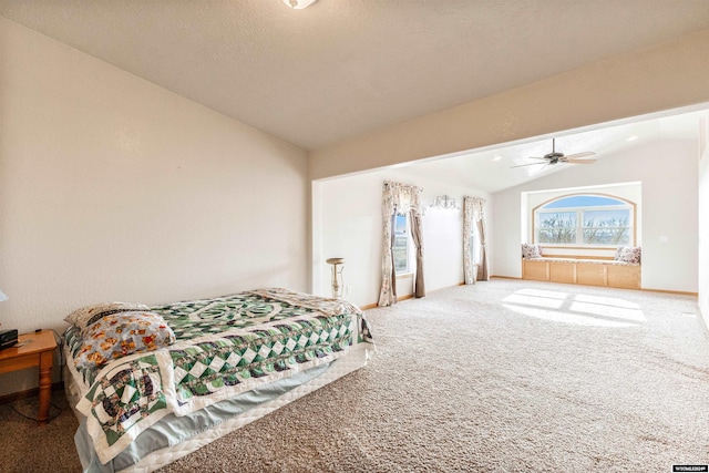 carpeted bedroom with a textured ceiling, ceiling fan, and lofted ceiling