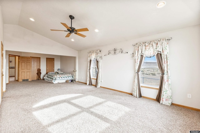 unfurnished bedroom featuring carpet, vaulted ceiling, and ceiling fan