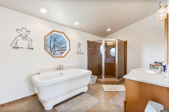 bathroom with tile patterned floors, vanity, lofted ceiling, and independent shower and bath