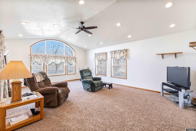 carpeted living room with ceiling fan and lofted ceiling