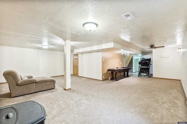 interior space featuring carpet, ceiling fan, and a textured ceiling