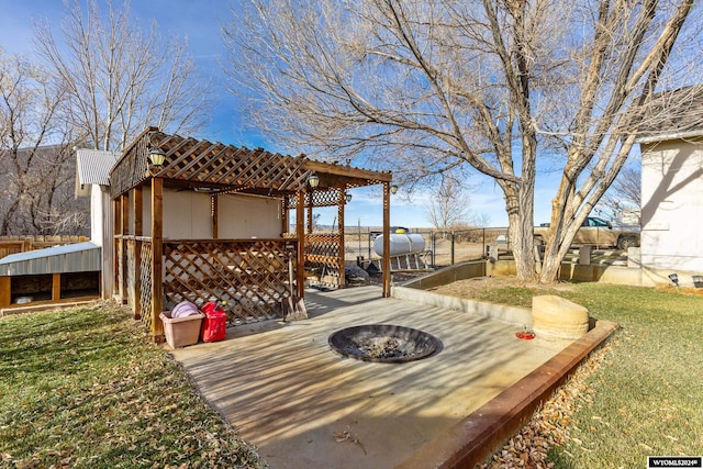 wooden deck featuring a fire pit and a yard