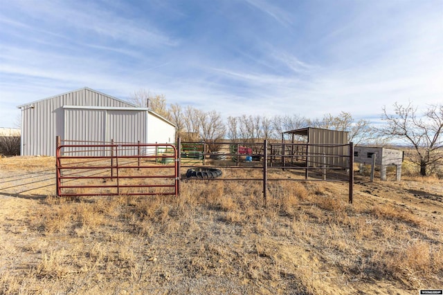 view of yard with an outbuilding and a rural view