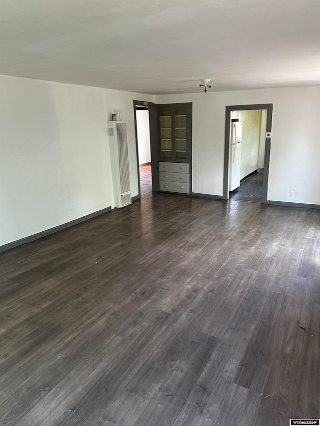 empty room featuring dark hardwood / wood-style flooring