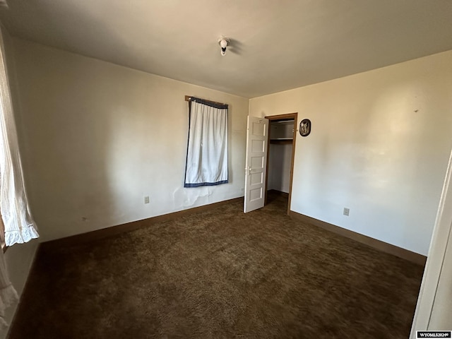 unfurnished bedroom featuring dark colored carpet