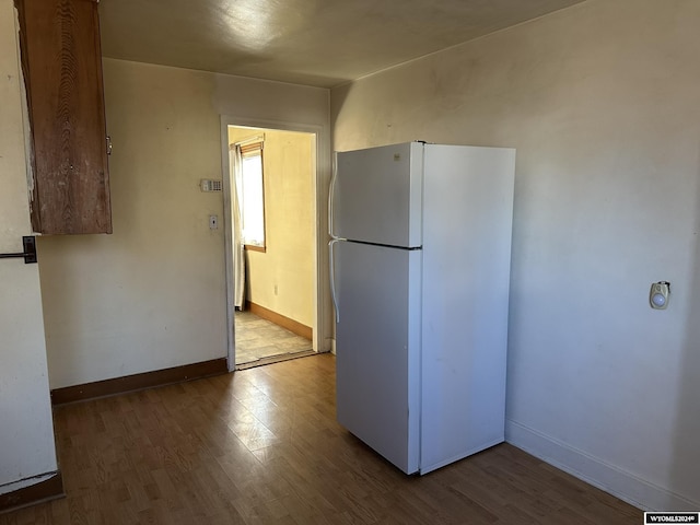 kitchen with hardwood / wood-style flooring and white fridge