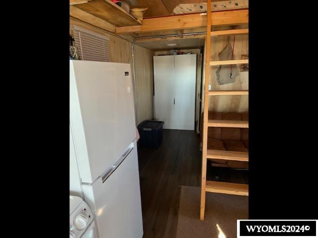 interior space with white fridge and dark hardwood / wood-style flooring