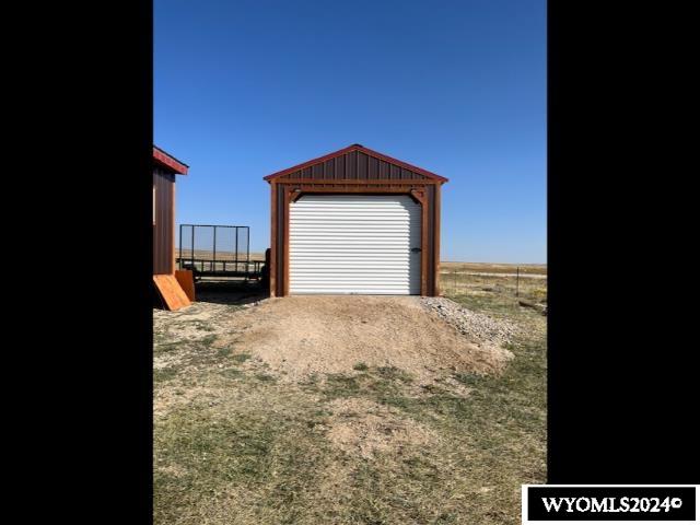 view of yard with a garage and an outdoor structure