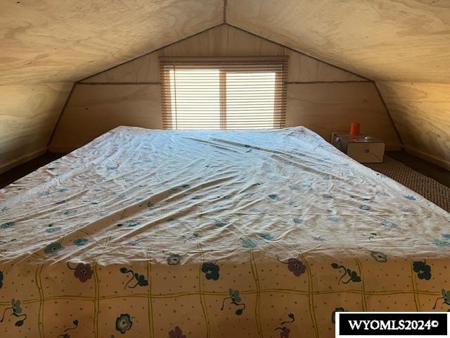 unfurnished bedroom with lofted ceiling