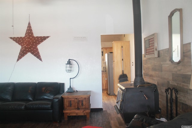 living room with a wood stove and dark hardwood / wood-style flooring