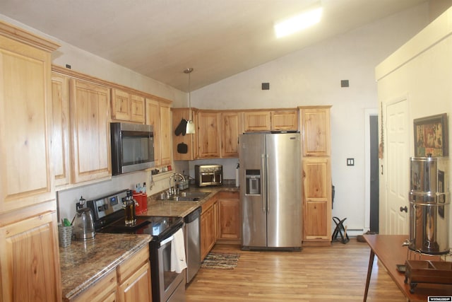 kitchen with sink, stainless steel appliances, high vaulted ceiling, pendant lighting, and light hardwood / wood-style floors