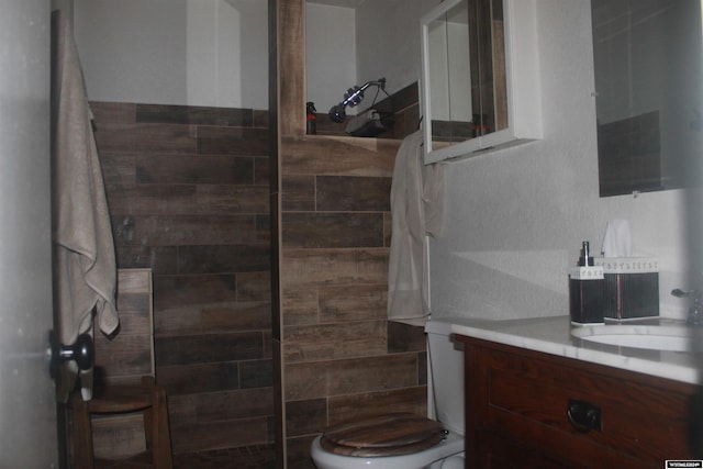 bathroom with vanity, toilet, and walk in shower