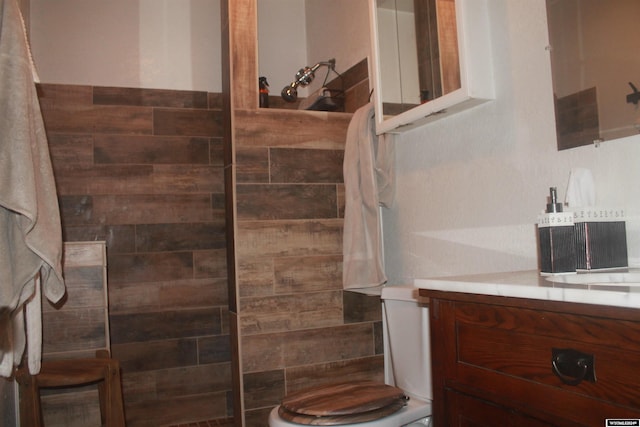 bathroom featuring vanity, toilet, and walk in shower