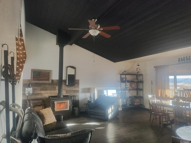 living room featuring a wood stove, ceiling fan, dark hardwood / wood-style flooring, and a wealth of natural light