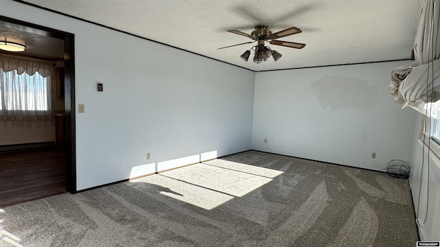 carpeted spare room featuring a textured ceiling, a baseboard radiator, and ceiling fan