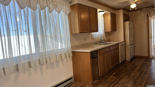 kitchen with dark hardwood / wood-style flooring, white appliances, a baseboard heating unit, crown molding, and sink