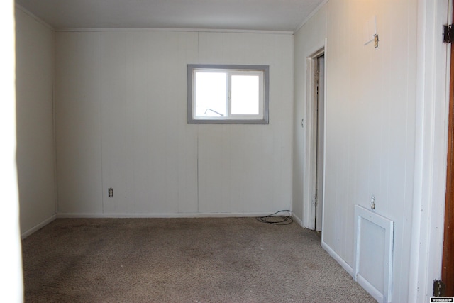 carpeted empty room featuring ornamental molding