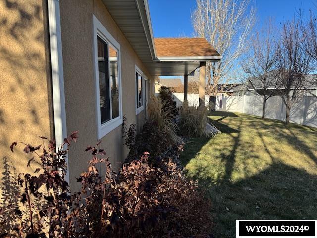 view of property exterior featuring a lawn