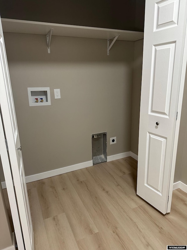 laundry area featuring electric dryer hookup, hookup for a washing machine, and light hardwood / wood-style flooring