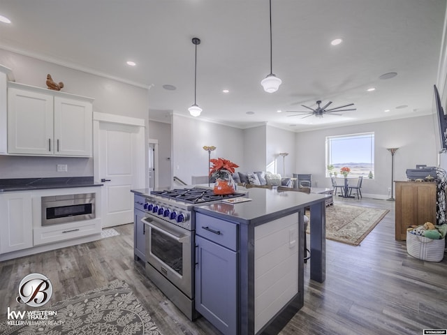 kitchen with white cabinetry, dark wood-type flooring, stainless steel appliances, decorative light fixtures, and ornamental molding