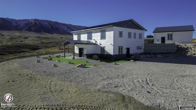 back of property with a mountain view