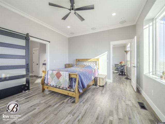 bedroom featuring ceiling fan, ornamental molding, and light wood-type flooring