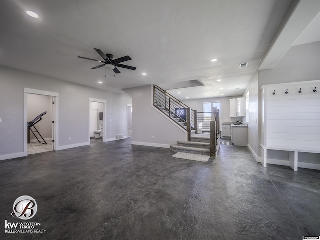 unfurnished living room with ceiling fan