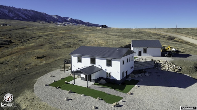 birds eye view of property with a mountain view