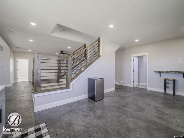 unfurnished living room featuring ceiling fan