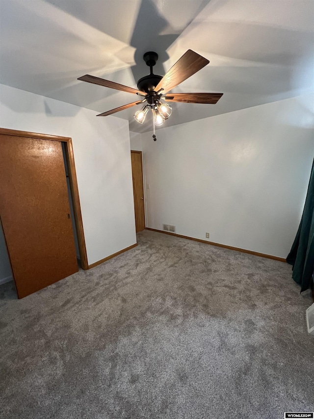 unfurnished bedroom featuring carpet and ceiling fan